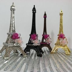 three miniature eiffel tower made out of glass beads and pink flowers on the base