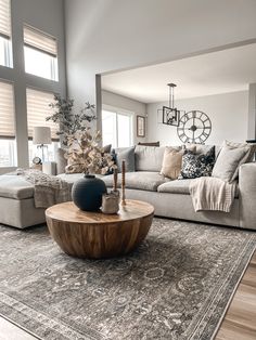 a living room filled with furniture and lots of windows