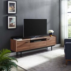 a living room scene with focus on the entertainment center and large window in the background