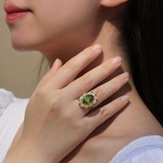 14K Solid Gold or Sterling Silver 1 Piece 10 x 14 mm Peridot｜Green｜Oval｜Eye Clean Peridot CTW: 7.50 10 Pieces 3 x 4 mm Opal｜Fire White｜Oval｜Eye Clean Opal CTW: 1.50 10 Pieces 2 mm Tsavorite｜Green｜Round｜Eye Clean Tsavorite CTW: 0.45 Ornament Measurements: 18 x 22 mm Total Item Weight (g): 6.50 Luxury Oval Tsavorite Jewelry, Green Multi-stone Oval Cabochon Jewelry, Oval Multi-stone Tsavorite Rings, Oval Tsavorite Multi-stone Ring, Oval Tsavorite Rings With Halo Setting, Oval Green Tsavorite Jewelry, Oval Tsavorite Jewelry For Anniversary, Round Eyes, Green Oval