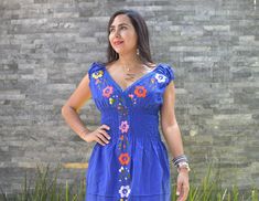 This lovely was handmade in Mexico. The beautiful colorful flowers were embroidered by hand, so each one is unique. You will love wearing this comfortable cotton dress with short sleeves. It is perfect for a hot summer day. This dress comes just above or below the knee, depending on how tall you are. It has a square neckline and cute little puffy sleeves. Inch measure Medium 18 * 35 Large 19* 37 XL 20* 37 XXL 21* 38 About Our Items: Each one of our items is handmade/hand woven by Indigenous comm Handmade Bohemian Dresses With Multicolor Embroidery, Handmade Folk Dresses For Spring, Handmade Blue Summer Dress, Handmade Blue Dresses For Spring, Traditional Handmade Summer Dresses, Huipil Dress, Mexican Embroidered Dress, Flowered Dress, Mexican Dress