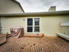 a patio with a grill cover on it