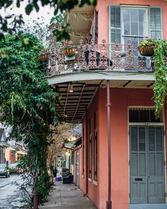 an apartment building with balconys and potted plants on the balconies