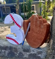 the letters are made out of wood and have baseballs painted on them, along with a bat