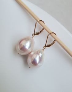 *Made with cultured medium size (13-14mm width, 17-20mm length, approx. 3.5-4.5 grams each pearl) Baroque shape freshwater pearls in natural white color, untreated non-dyed, natural color, smooth surface and excellent luster, with natural blemishes * With 13mm 14K gold filled hoops or 14k gold filled French ear wires, or 14k gold filled lever backs. Sterling silver metal is available upon request (silver color) *Earring measurement: length: 37mm width: 14mm *The pearls themselves (average) measu Red Garnet Earrings, Pearl Lariat Necklace, Pearl Strands Necklace, Gold Filled Hoops, Baroque Pearl Earrings, Gold Choker, Garnet Earrings, Akoya Pearls, Tahitian Pearls