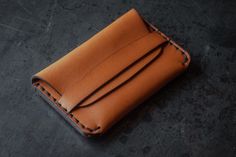 a brown leather wallet sitting on top of a table