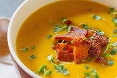 a close up of a bowl of soup with bacon