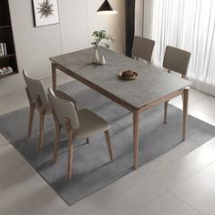 a dining table with four chairs around it