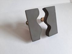 two gray door handles on top of white paper