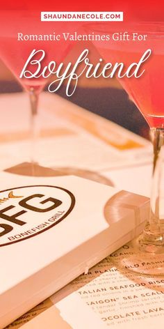 two martini glasses sitting on top of a table next to a book with the title romantic valentine's gift for boyfriend