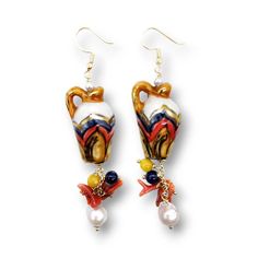 "The Sicilian earrings with Caltagirone ceramic amphora are a true work of art. The craftsmanship of Caltagirone ceramics makes each amphora unique and special. Combined with precious stones such as yellow jade, lapis lazuli, natural freshwater pearls, baroque pearl and Mediterranean red coral. These jewels are a modern interpretation of the Sicilian tradition and a perfect combination of art, culture and design. The hook is in gold plated 925 silver. The ceramic element depicts \"the amphorae\" Handmade Mediterranean Jewelry For Gift, Caltagirone Ceramics, Arabesque Design, River Pearls, Yellow Jade, Handmade Jewel, Art Culture, Rainbow Design, Gold Decor