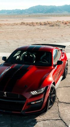 a red and black sports car parked in a parking lot