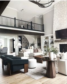 a living room filled with lots of furniture and a large tv mounted to the wall