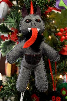 a gray stuffed animal hanging from a christmas tree