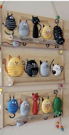 several cat magnets are hanging on the wall in front of two wooden peg boards