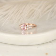 Pop the bubbly! This new version of our Thea ring features a blush champagne sapphire with diamond clusters on each side. #rings #engagementrings #weddingrings #rosadosbox #rosegold #blush #champagne #sapphire #gemstone #diamonds #artdeco #cluster #oval #unique #oneofakind #jewelry #finejewelry #gifts Luxury Oval Morganite Wedding Ring, Gia Certified Morganite Rings In Fine Jewelry Style, Oval Morganite Jewelry For Proposal, Morganite Rings Gia Certified For Anniversary, Oval Anniversary Rings With Side Stones, Oval Rings With Side Stones For Anniversary, Oval Jewelry With Side Stones For Gift, Gift Oval Jewelry With Side Stones, Gift Jewelry With Oval Side Stones