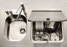 a stainless steel sink with an open dishwasher