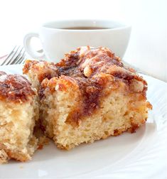 two pieces of cake on a plate next to a cup of coffee