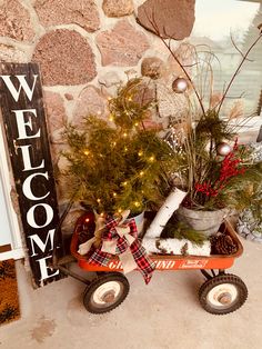 a wagon filled with christmas decorations next to a welcome sign