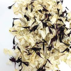 dried flower petals on a white surface