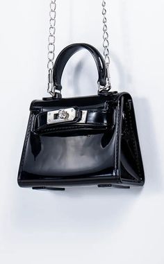 Embrace the tiny bag trend and go the extra mile with our Itsy Bitsy bags. The Jade is a ridiculously cute patent leather black mini bag with a metal chain strap for carrying over the shoulder and a small black handle for clutch carry. A classic handbag shape but in miniature topped off with a meta lock feature at front. Big enough to fit your absolute essentials such as keys and lip gloss. Measures: 11cm length, 8.5 cm height, 5cm width Chic Black Bag With Glossy Finish, Trendy Formal Bag With Glossy Finish, Trendy Formal Bags With Glossy Finish, Trendy Glossy Finish Formal Bags, Gothic Bags, Black Mini Bag, Gothic Bag, Tiny Bag, Mini Handbag