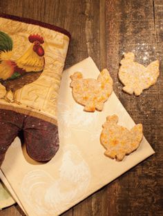 an oven mitt and some cookies on a table