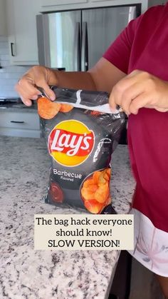 a person standing in front of a bag of chips with the caption says, the bag hack everyone should know slow version