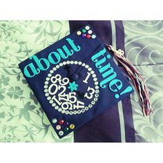 a blue graduation cap with the words about time on it and a tassell