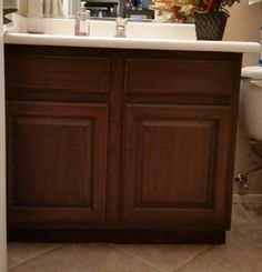 a bathroom with a sink, mirror and toilet paper roll on the counter next to it