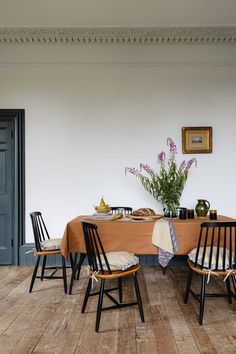 a dining room table with four chairs around it