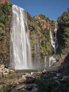 a large waterfall with a rainbow in the sky