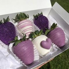 there are four chocolate covered strawberries in the box