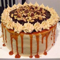 there is a cake that has been decorated with nuts and caramel on the top