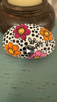 a decorated rock sitting on top of a table