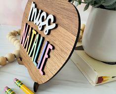 a wooden sign with the words miss and mr on it next to some crayons