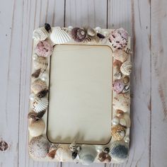 there is a frame made out of seashells