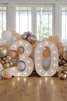 the number 30 is surrounded by balloons and streamers in gold, silver and white