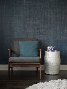 a chair sitting in front of a blue wall