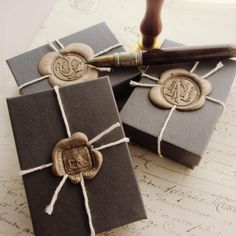 two gift boxes tied with twine and wax stamp