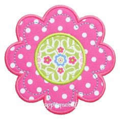 a pink and green flower with white polka dots on the center is featured in this applique design