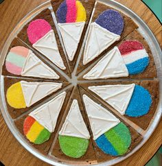 there is a cake decorated with different colors and shapes on the plate, along with other desserts