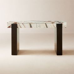 a marble table with metal legs on a white background