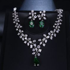 Make a stunning statement with this exquisite jewelry set, featuring a captivating emerald green cubic zircon necklace and earrings. Whether you're attending a wedding, a special event, or simply want to add a touch of sophistication to your ensemble, this set is the perfect choice. Key Features: Designed for the trend-conscious individual Elegant geometric shape and pattern Suitable for weddings and other special occasions Made of high-quality copper and adorned with shimmering cubic zirconia I Green Jewel Bridal Necklace For Anniversary, Green Jeweled Bridal Necklace For Anniversary, Hand Set Emerald Necklace With Cubic Zirconia For Party, Hand Set Cubic Zirconia Emerald Necklace For Party, Anniversary Green Jeweled Bridal Necklace, Hand-set Cubic Zirconia Emerald Necklace For Party, Green Jewels Jewelry Sets For Anniversary, Green Jeweled Jewelry Sets For Anniversary, Green Jeweled Anniversary Jewelry Sets