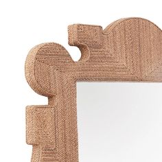 a mirror that is made out of jute and has an intricate design on it