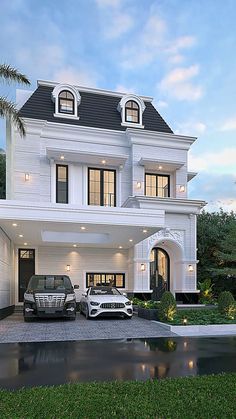 two cars parked in front of a large white house