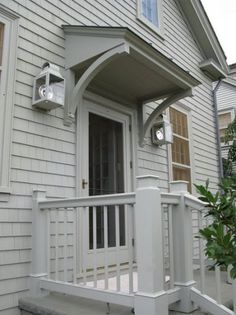 the front porch of a house with white railings