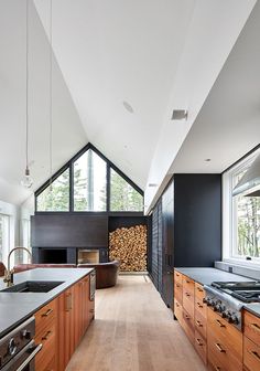 a kitchen with wooden cabinets and an island in front of a stove top oven next to a window