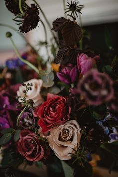 a bunch of flowers that are sitting in a vase on top of a table,