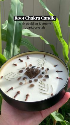 a hand holding a bowl filled with white liquid and brown flakes on top of it