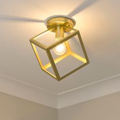 a light that is on the ceiling in a room with white walls and flooring